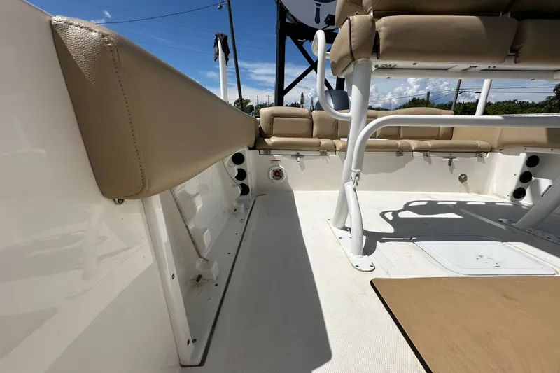 Slide: The Image of 2020 NauticStar 2302 Legacy boat interior with beige seating and white deck. - 81