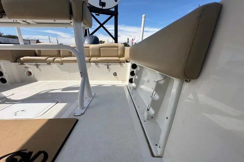 Slide: The Image of 2020 NauticStar 2302 Legacy boat interior with beige seating and white deck. - 82