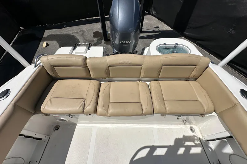 Slide: The Image of 2020 NauticStar 2302 Legacy boat interior with tan seating and Yamaha 200 engine. - 84
