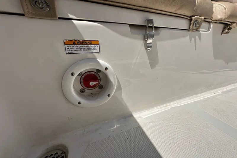 Slide: The Image of 2020 NauticStar 2302 Legacy boat interior with safety warning and control switch. - 85