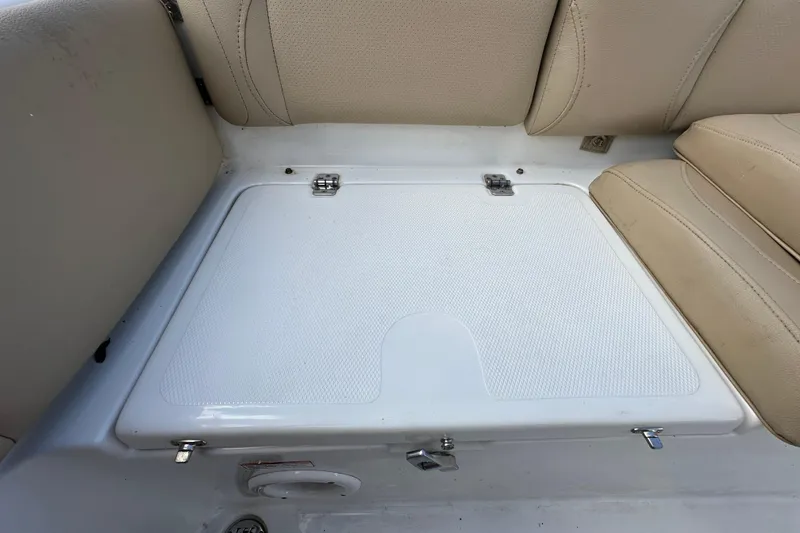 Slide: The Image of 2020 NauticStar 2302 Legacy boat seating area with storage compartment. - 86