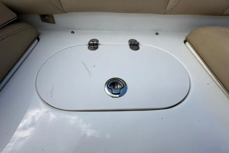 Slide: The Image of 2020 NauticStar 2302 Legacy boat storage compartment with beige seating. - 88