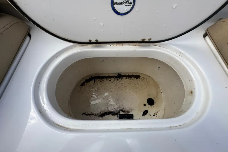 Slide: The Image of Open storage compartment on 2020 NauticStar 2302 Legacy boat, showing interior details. - 89