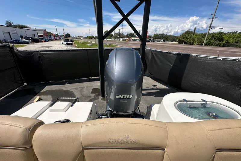Slide: The Image of 2020 NauticStar 2302 Legacy boat with Yamaha 200 engine, outdoor setting. - 92