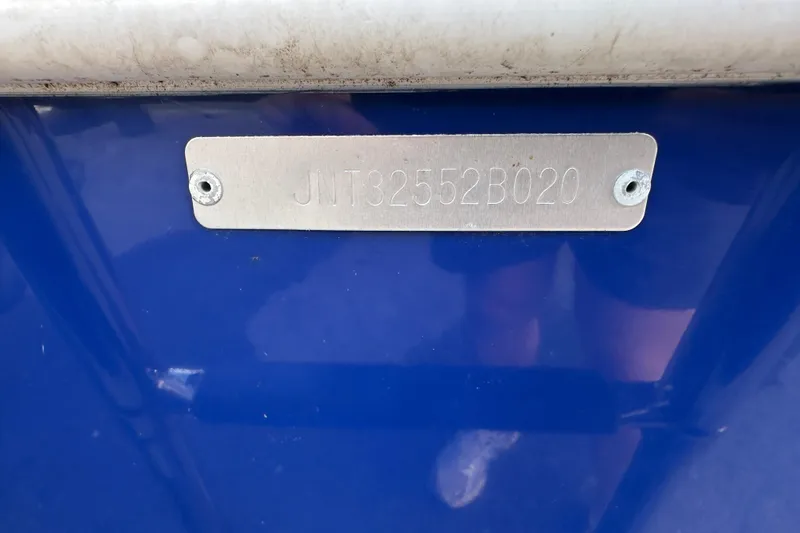 Slide: The Image of 2020 NauticStar 2302 Legacy boat hull identification number on blue surface. - 97