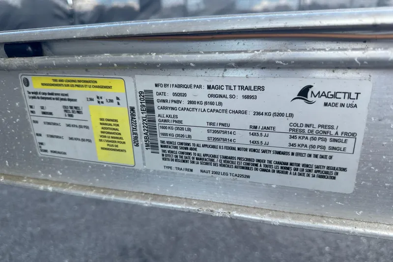 Slide: The Image of Label on Magic Tilt trailer for NauticStar 2302 Legacy, 2020 model, showing tire and loading information. - 98
