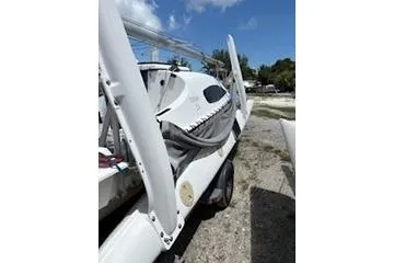 The Image of 2003 Corsair F-24MKII sailboat on trailer, parked outdoors under blue sky. - 1