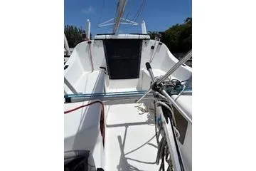 Slide: The Image of 2003 Corsair F-24MKII sailboat cockpit with rigging, white interior, and blue sky background. - 3