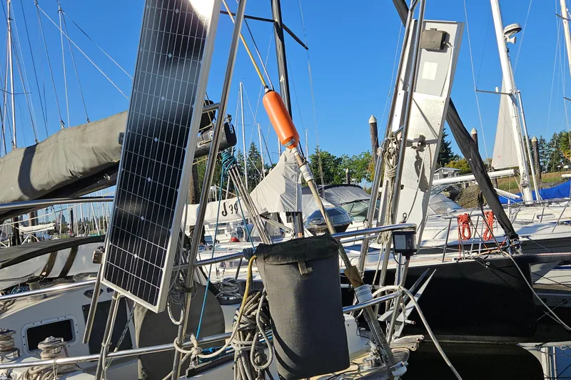 Slide: The Image of Sailboat with solar panels docked, Fast Passage 39 model, 1979. - 11