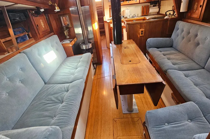 Slide: The Image of Interior of 1979 Fast Passage 39 sailboat with cozy seating and wooden table. - 13