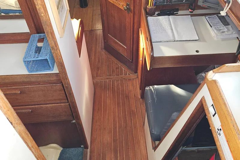 Slide: The Image of Interior of 1979 Fast Passage 39 sailboat with wooden flooring and navigation desk. - 15