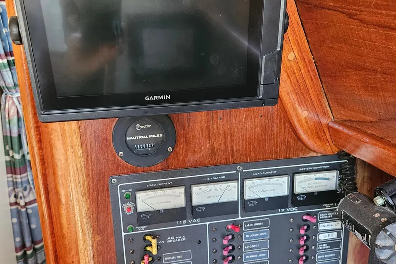 Slide: The Image of Control panel of a 1979 Fast Passage 39 sailboat with Garmin display and nautical miles gauge. - 18