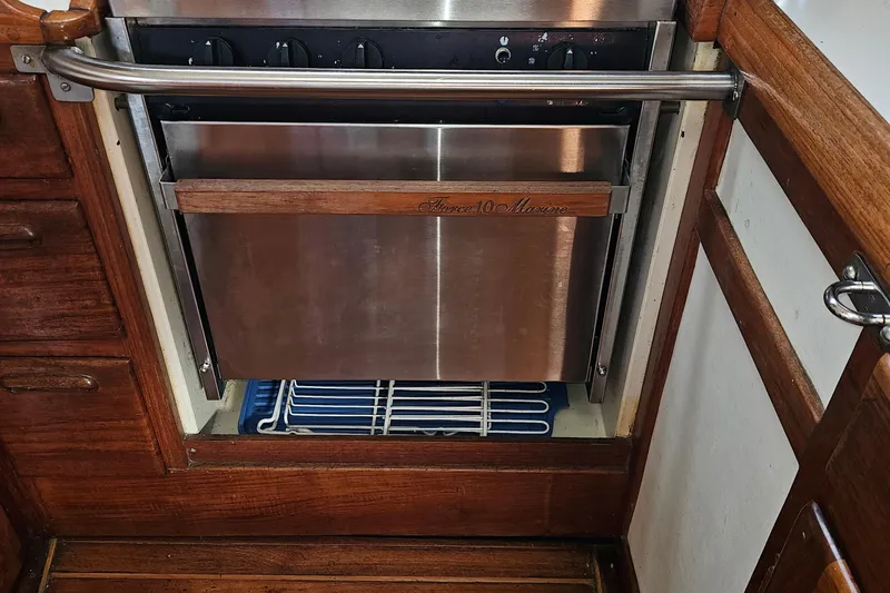 Slide: The Image of Stainless steel marine oven in a 1979 Fast Passage 39 sailboat galley. - 23