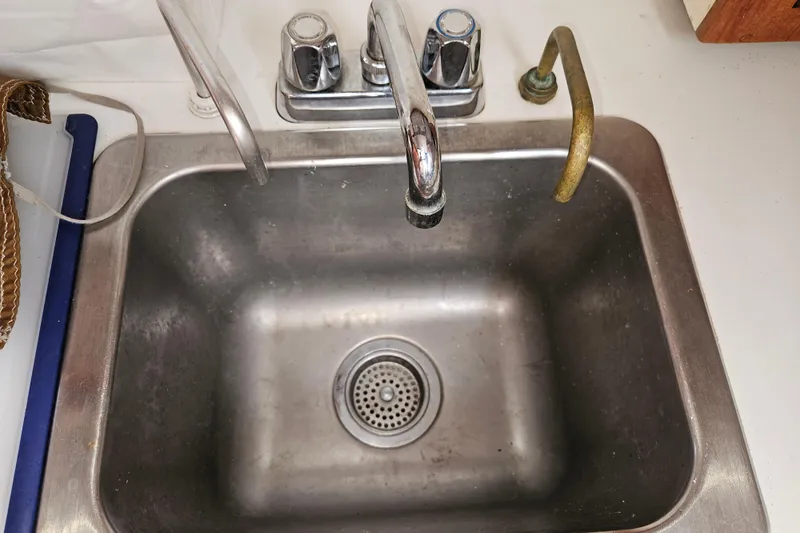 Slide: The Image of Stainless steel sink with dual faucets on a 1979 Fast Passage 39 boat. - 24