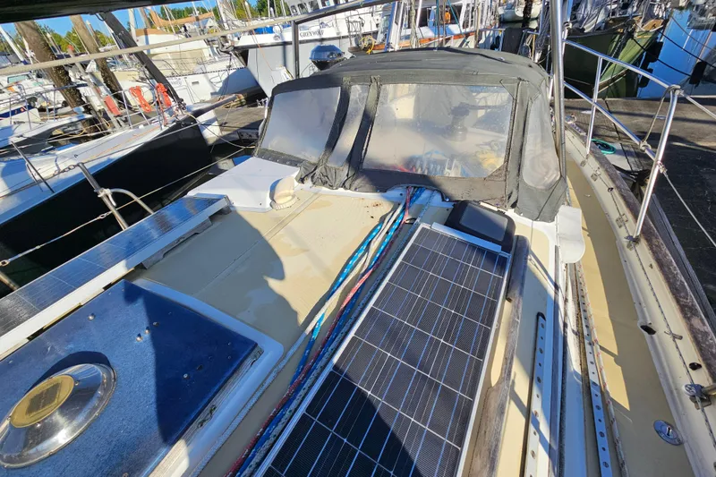 Slide: The Image of 1979 Fast Passage 39 sailboat deck with solar panels and cockpit cover. - 3