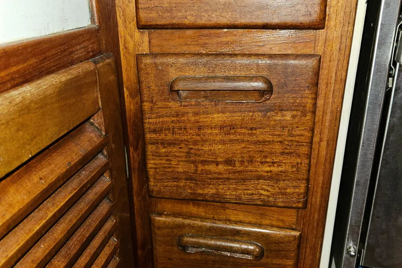 Slide: The Image of Wooden cabinet drawers on a 1979 Fast Passage 39 boat interior. - 33