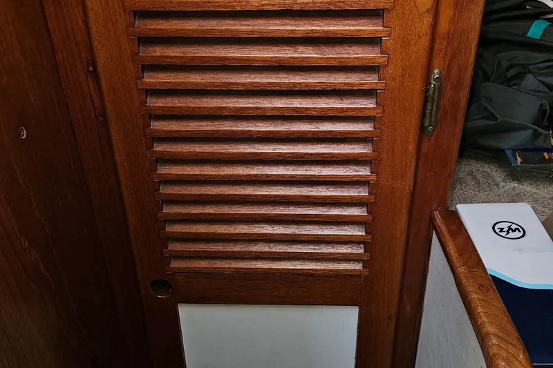 Slide: The Image of Wooden louvered door inside a 1979 Fast Passage 39 sailboat cabin. - 34