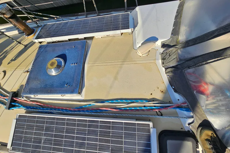 Slide: The Image of Deck of 1979 Fast Passage 39 sailboat with solar panels and ropes. - 4