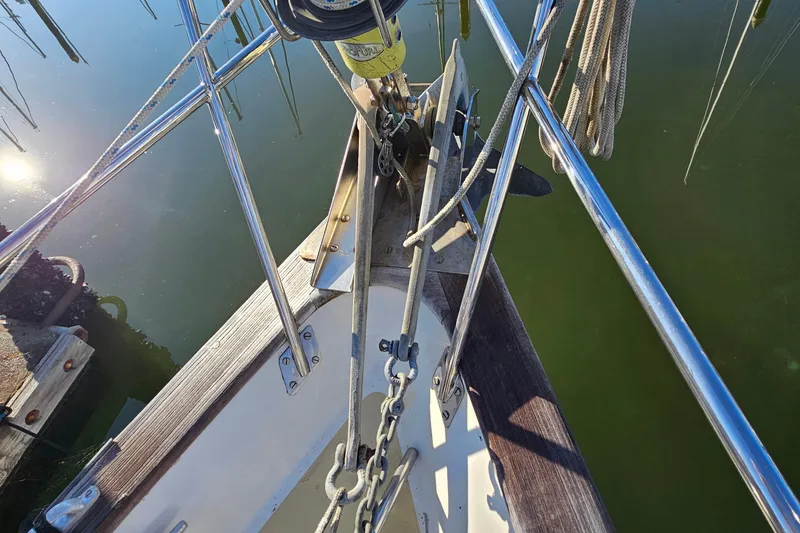 Slide: The Image of Bow of 1979 Fast Passage 39 sailboat with anchor and ropes in marina. - 7