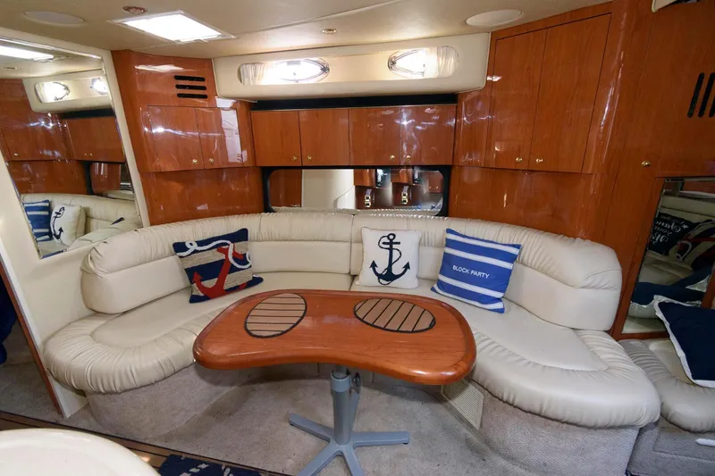 Slide: The Image of Luxurious interior of 2000 Sea Ray 380 Sundancer with plush seating and nautical decor. - 10