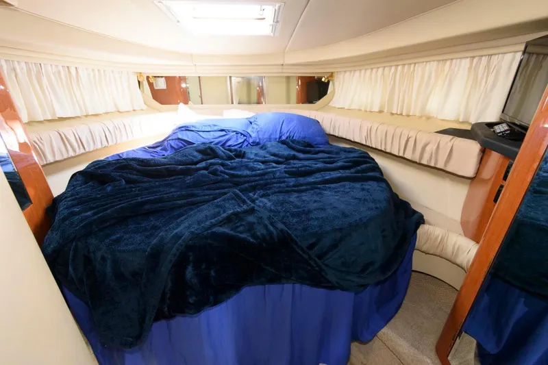 Slide: The Image of Luxurious cabin interior of 2000 Sea Ray 380 Sundancer with cozy bedding. - 13