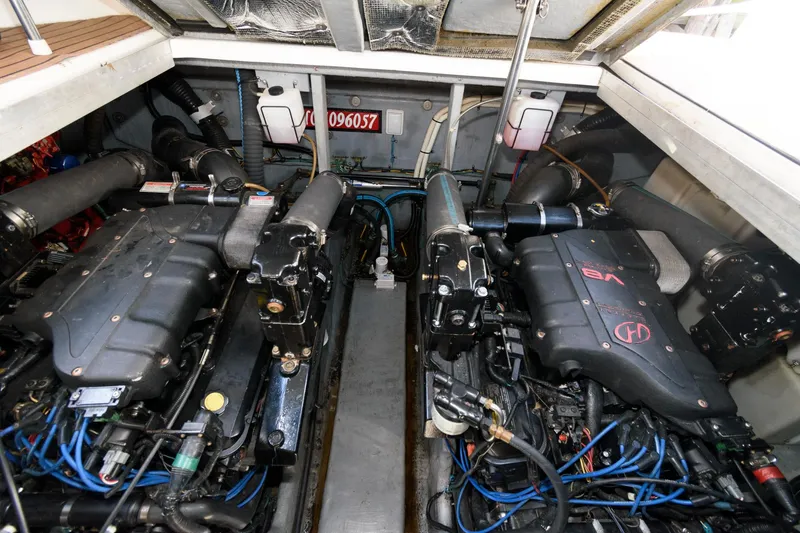 Slide: The Image of Engine compartment of 2000 Sea Ray 380 Sundancer with dual engines and wiring. - 16
