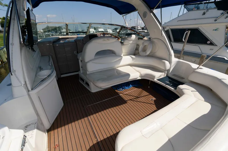Slide: The Image of Luxurious 2000 Sea Ray 380 Sundancer yacht interior with white seating and wooden flooring. - 3