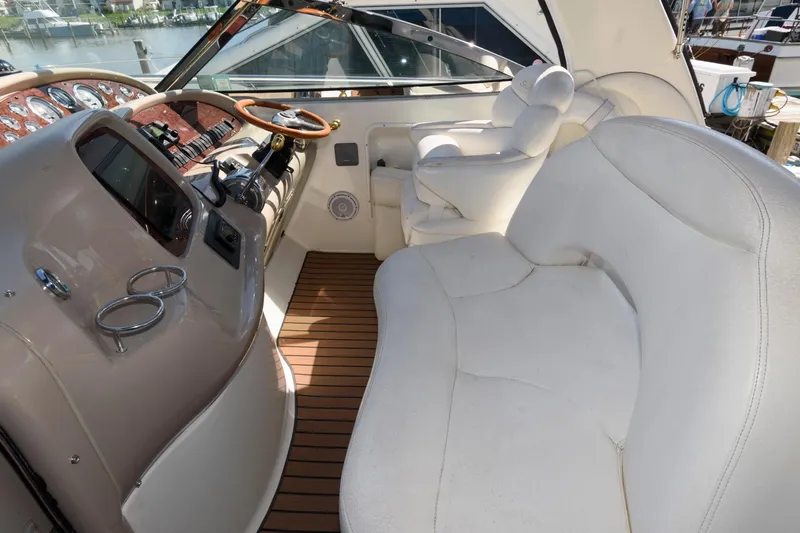 Slide: The Image of Interior of 2000 Sea Ray 380 Sundancer yacht with plush seating and wooden accents. - 4