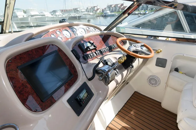 Slide: The Image of 2000 Sea Ray 380 Sundancer helm with wood accents and modern controls. - 5