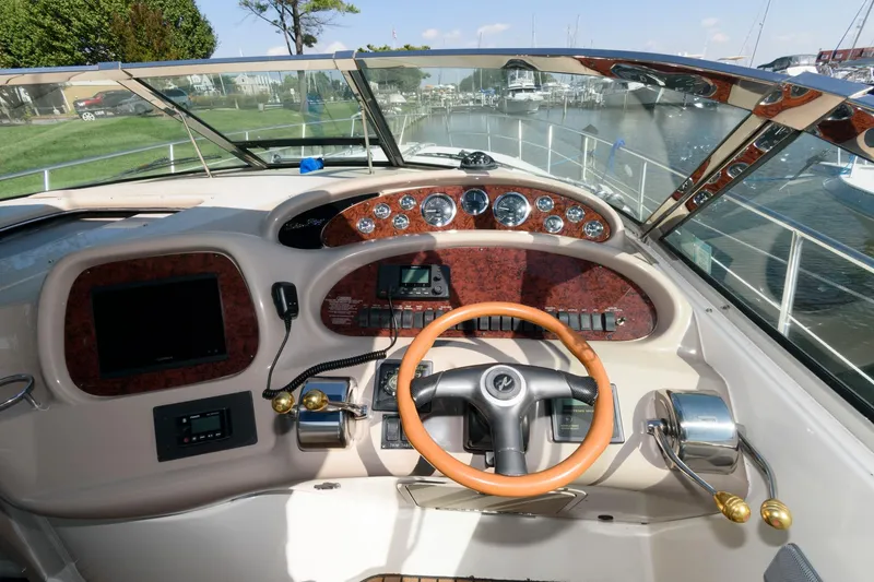 Slide: The Image of Cockpit of 2000 Sea Ray 380 Sundancer with wood accents and modern controls. - 6