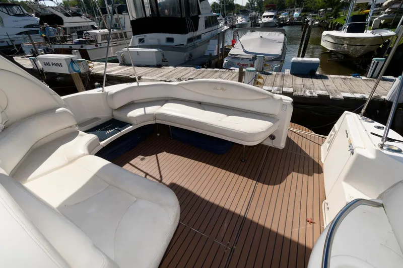 Slide: The Image of Sea Ray 380 Sundancer 2000 boat interior with white seating and wooden deck. - 7