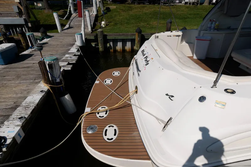 Slide: The Image of Sea Ray 380 Sundancer 2000 docked, showing rear deck and mooring lines. - 9
