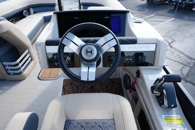 Slide: The Image of 2026 Harris Grand Mariner 250 boat dashboard with steering wheel and control panel. - 12
