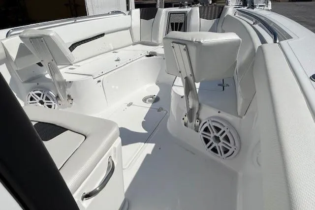 Slide: The Image of 2025 Wellcraft 243 Fisherman boat interior with white seating and speakers. - 11