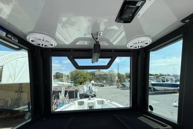 Slide: The Image of Interior view of 2025 Wellcraft 243 Fisherman boat with speakers and window. - 13