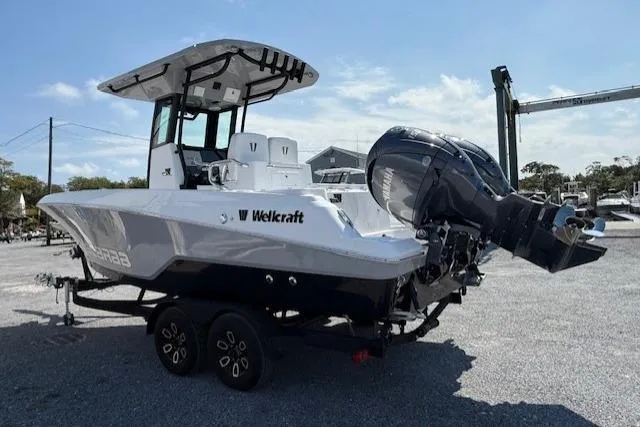 Slide: The Image of 2025 Wellcraft 243 Fisherman boat on trailer, featuring sleek design and powerful outboard engine. - 3