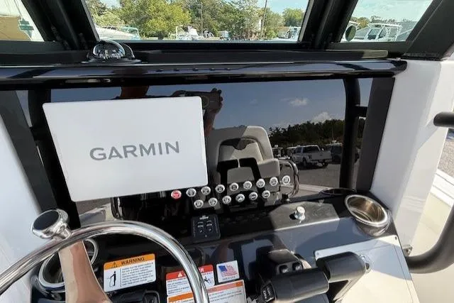 Slide: The Image of 2025 Wellcraft 243 Fisherman boat dashboard with Garmin navigation system. - 5