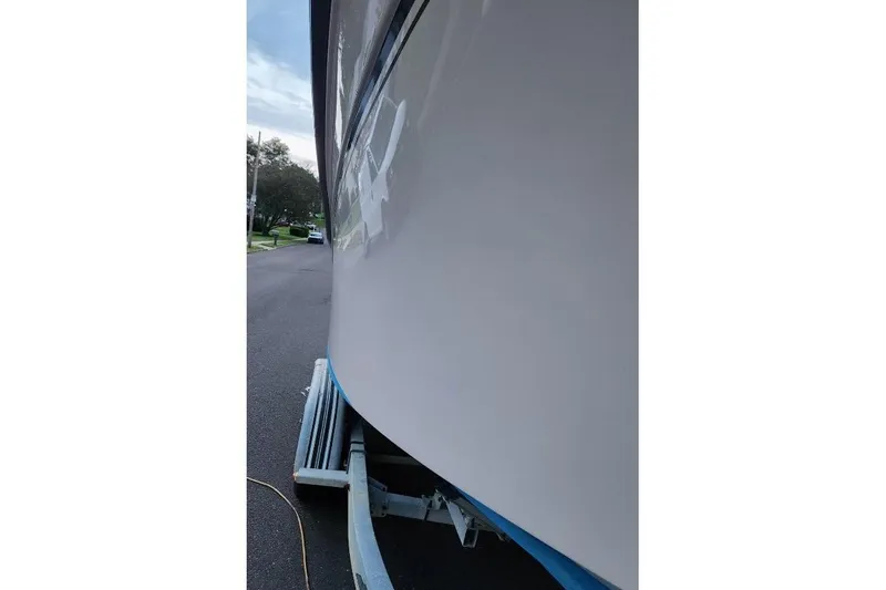 Slide: The Image of Side view of a 1999 Grady-White Advance 247 boat on a trailer. - 10