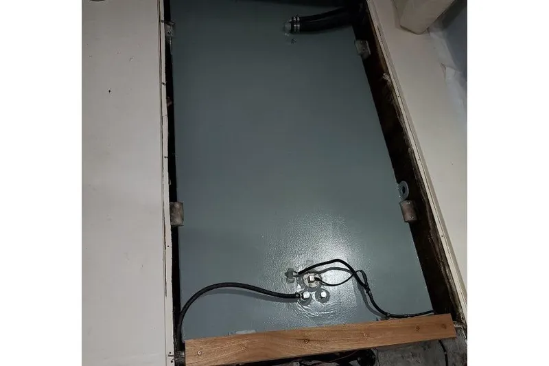 Slide: The Image of 1999 Grady-White Advance 247 boat component with wiring and metal panel. - 11