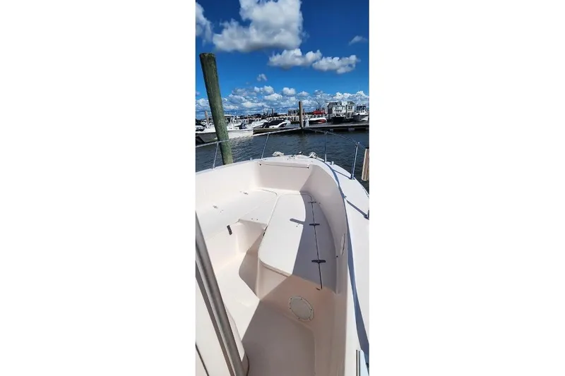 Slide: The Image of 1999 Grady-White Advance 247 boat docked at marina under blue sky. - 15