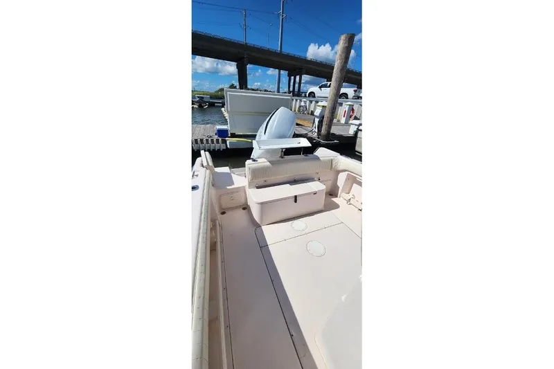 Slide: The Image of 1999 Grady-White Advance 247 boat interior at dock, under clear blue sky. - 16