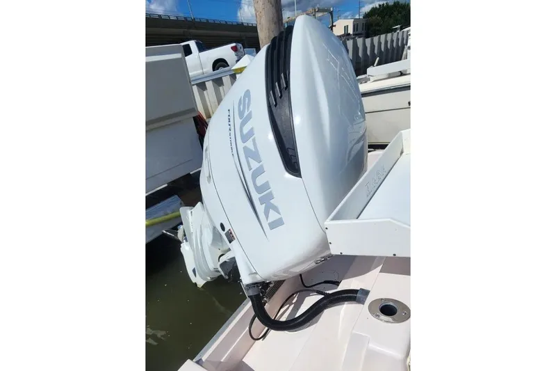 Slide: The Image of 1999 Grady-White Advance 247 boat with Suzuki outboard motor in marina setting. - 17