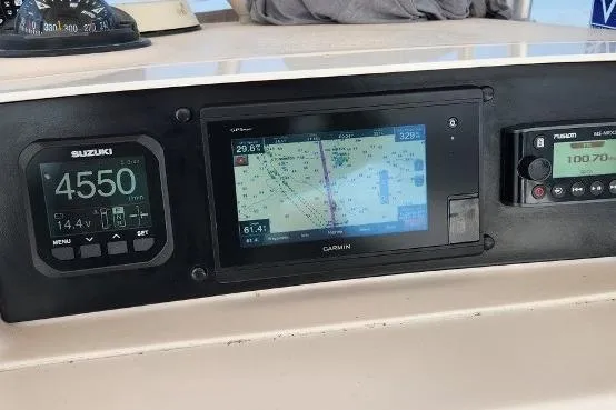 Slide: The Image of Dashboard of a 1999 Grady-White Advance 247 boat with navigation and engine displays. - 21