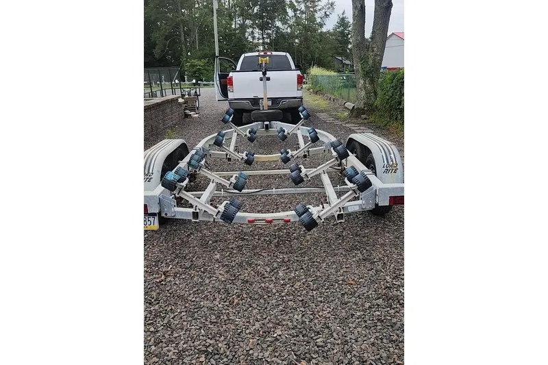 Slide: The Image of Boat trailer attached to a truck, suitable for Grady-White Advance 247, 1999 model. - 23