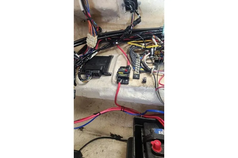 Slide: The Image of Electrical wiring and components inside a 1999 Grady-White Advance 247 boat. - 25