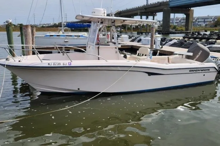 Slide: The Image of 1999 Grady-White Advance 247 boat docked in marina, side view. - 3