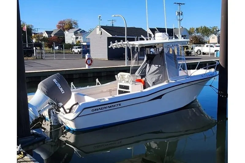 Slide: The Image of 1999 Grady-White Advance 247 boat docked with Suzuki outboard motor. - 4