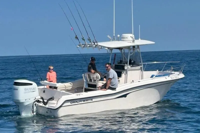 Slide: The Image of 1999 Grady-White Advance 247 boat with Suzuki engine on open water. - 5