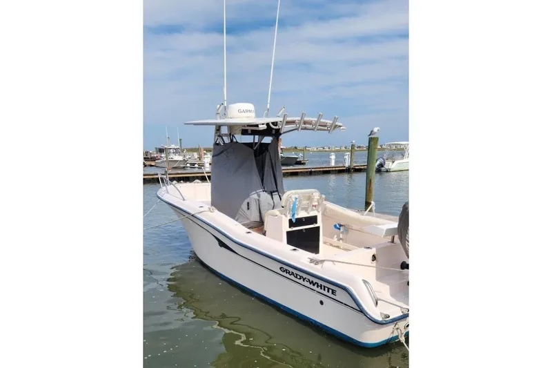 Slide: The Image of 1999 Grady-White Advance 247 boat docked in marina, clear sky background. - 6