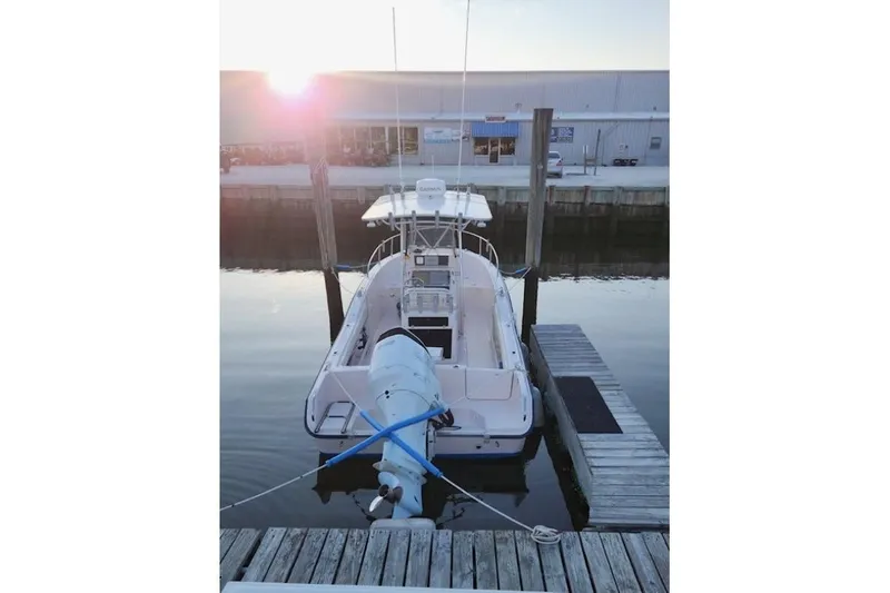 Slide: The Image of 1999 Grady-White Advance 247 boat docked at marina during sunset. - 7